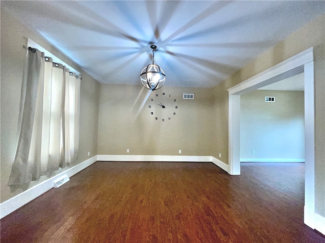 unfurnished dining area with dark wood-style flooring and baseboards