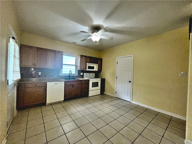 kitchen with white appliances, light tile patterned flooring, a ceiling fan, a sink, and tasteful backsplash