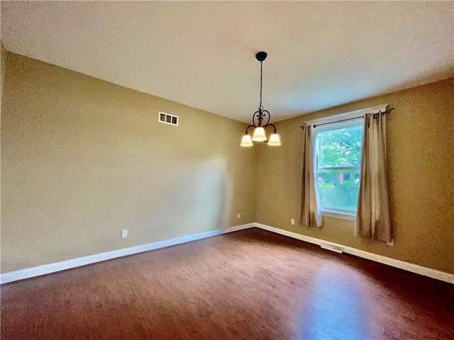 empty room with dark wood-style flooring and baseboards