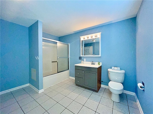 full bathroom with tile patterned floors, toilet, vanity, combined bath / shower with glass door, and baseboards