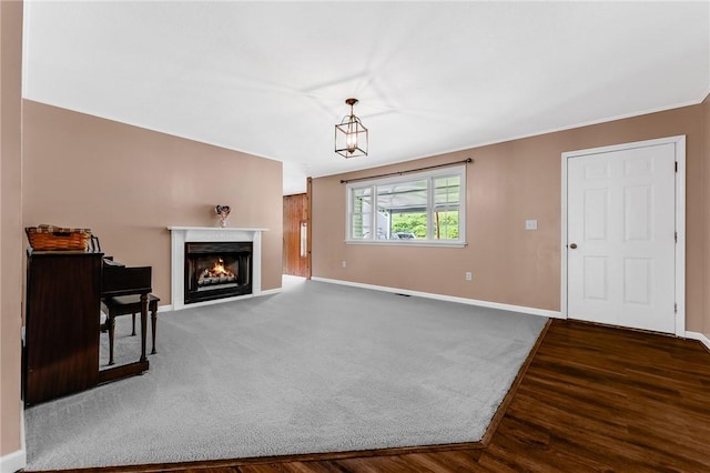 431 Mount Morris Rd, Kirby/Mtmorris, PA 15349 - unfurnished living room featuring baseboards, a lit fireplace, wood finished floors, and crown molding