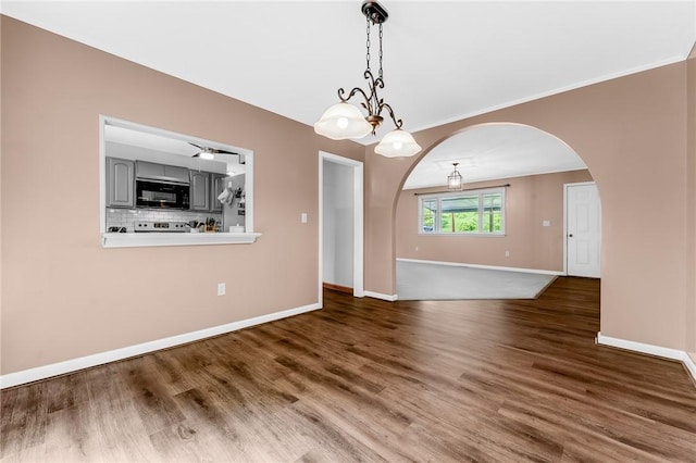 431 Mount Morris Rd, Kirby/Mtmorris, PA 15349 - spare room featuring arched walkways, baseboards, wood finished floors, and crown molding