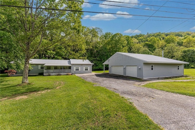 431 Mount Morris Rd, Kirby/Mtmorris, PA 15349 - ranch-style home featuring a detached garage, an outdoor structure, a front lawn, and metal roof