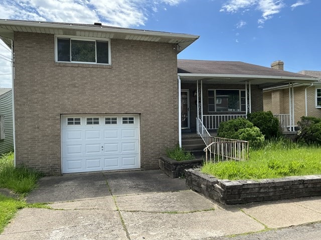 13 Schoen St, Mckees Rocks, PA 15136 - split level home featuring an attached garage, a porch, driveway, and brick siding