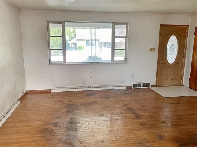 13 Schoen St, Mckees Rocks, PA 15136 - foyer entrance featuring a baseboard heating unit, a baseboard radiator, wood finished floors, and baseboards