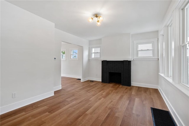 123 Bascom Ave, Observatory Hill, PA 15214 - unfurnished living room with wood finished floors, baseboards, and a brick fireplace