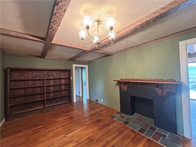 508 Woodside Rd, Forest Hills Boro, PA 15221 - unfurnished living room with wood finished floors, beamed ceiling, a fireplace, a chandelier, and a textured ceiling