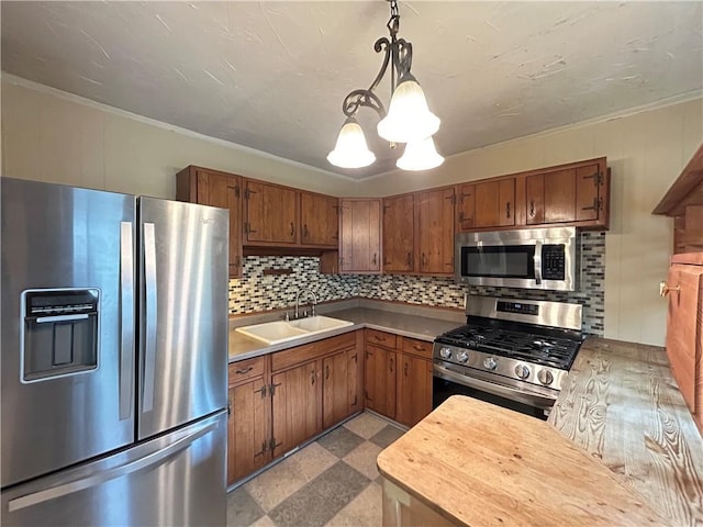 508 Woodside Rd, Forest Hills Boro, PA 15221 - kitchen featuring appliances with stainless steel finishes, a sink, a chandelier, brown cabinets, and tile patterned floors