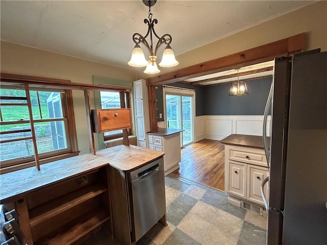 508 Woodside Rd, Forest Hills Boro, PA 15221 - kitchen featuring appliances with stainless steel finishes, healthy amount of natural light, a chandelier, a wainscoted wall, and hanging light fixtures