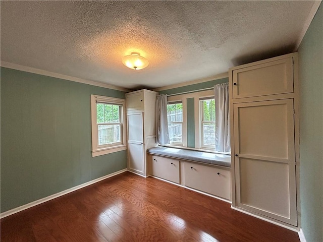 508 Woodside Rd, Forest Hills Boro, PA 15221 - unfurnished bedroom with dark wood finished floors, a textured ceiling, crown molding, and baseboards