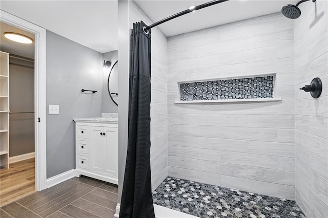 3289 Dawson St Unit 1, Oakland, PA 15213 - bathroom featuring a tile shower, vanity, a walk in closet, and baseboards