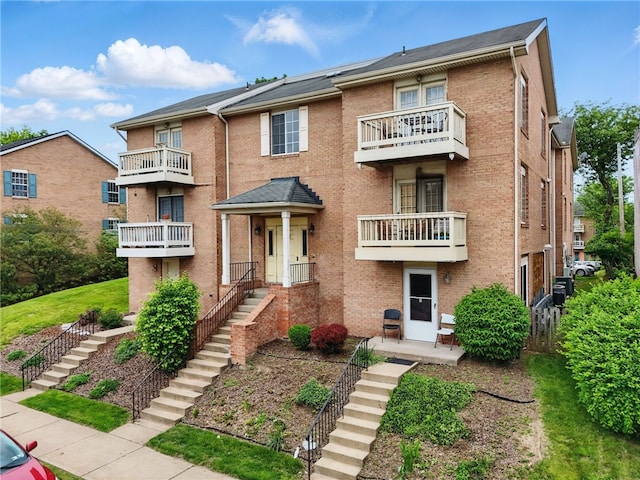 3289 Dawson St Unit 1, Oakland, PA 15213 - view of front facade featuring a balcony, stairs, and brick siding