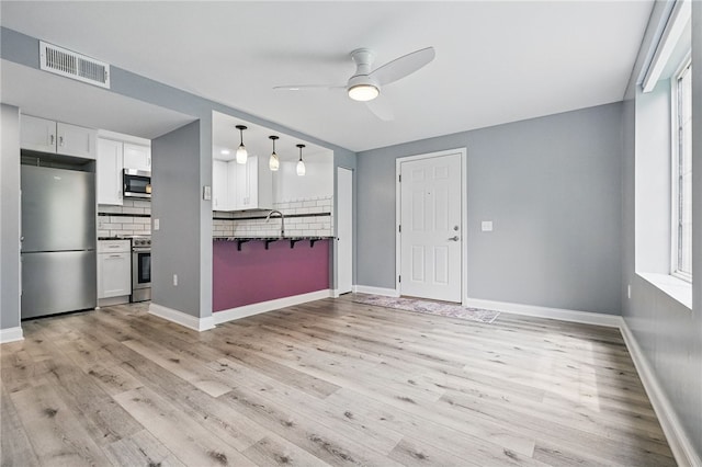 3289 Dawson St Unit 1, Oakland, PA 15213 - unfurnished living room featuring ceiling fan, light wood-style flooring, baseboards, and a sink