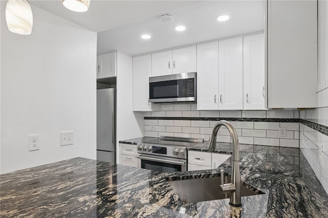 3289 Dawson St Unit 1, Oakland, PA 15213 - kitchen featuring appliances with stainless steel finishes, a sink, dark stone countertops, tasteful backsplash, and white cabinetry