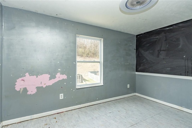 spare room featuring baseboards
