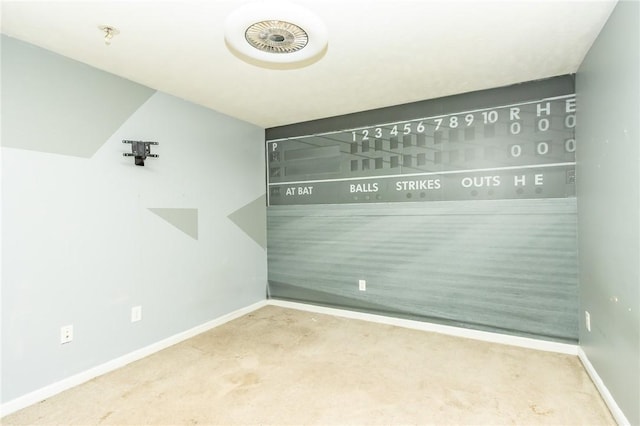 spare room featuring carpet flooring, baseboards, and fire sprinkler in ceiling
