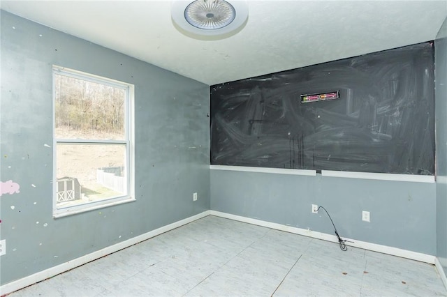 spare room with baseboards