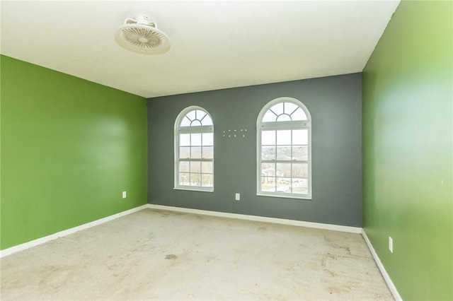 unfurnished room with baseboards and carpet flooring