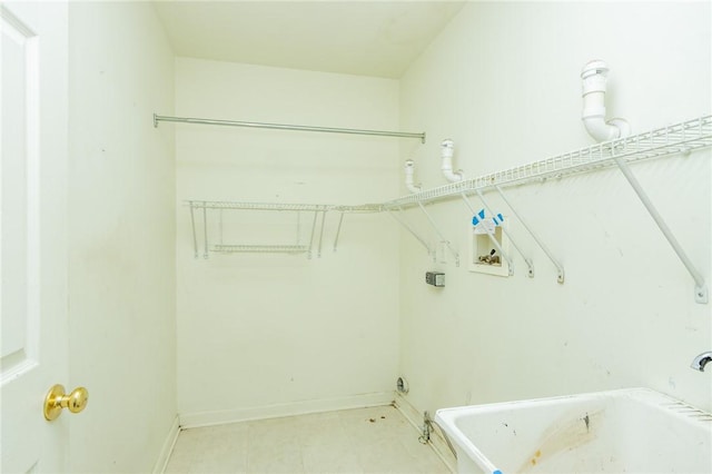 washroom with washer hookup and baseboards