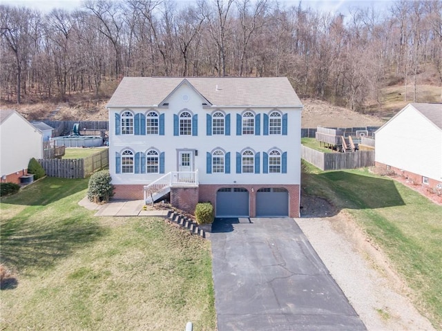 view of front of home with a garage, asphalt driveway, stairs, and brick siding