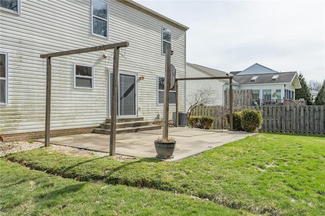 back of property with entry steps and a patio area