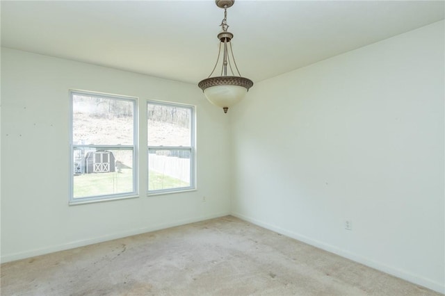 empty room featuring baseboards and carpet flooring