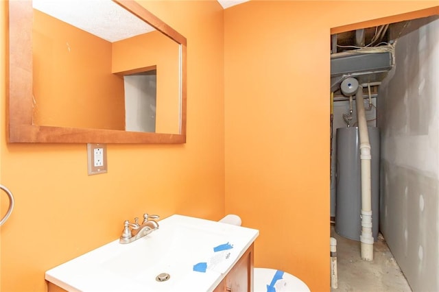half bathroom with gas water heater, unfinished concrete flooring, vanity, and toilet