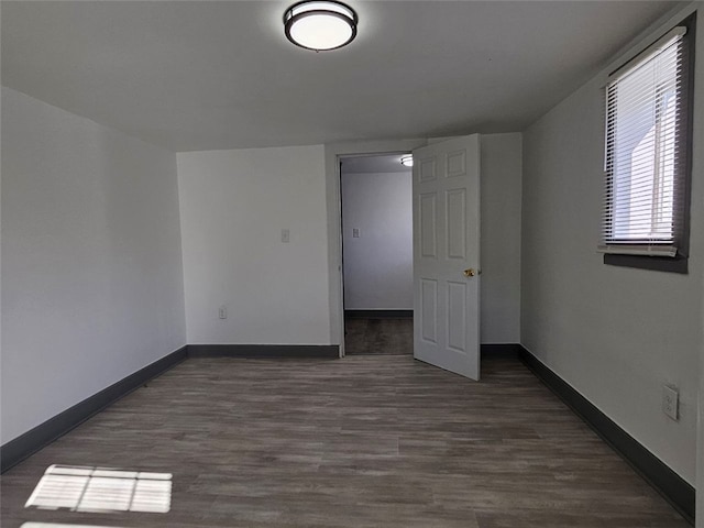 unfurnished bedroom featuring baseboards and wood finished floors