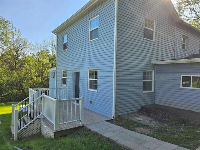 view of side of home featuring a wooden deck