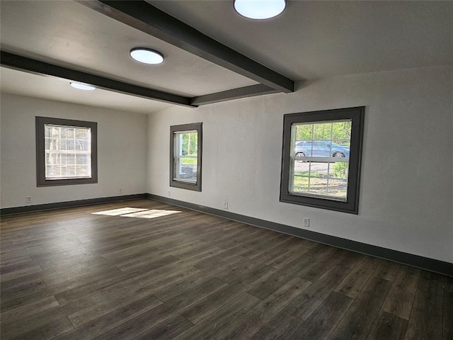 unfurnished room with beamed ceiling, dark wood-type flooring, healthy amount of natural light, and baseboards