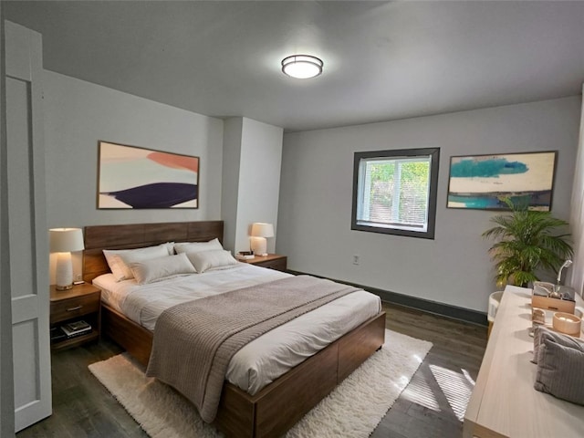 bedroom featuring dark wood-type flooring and baseboards