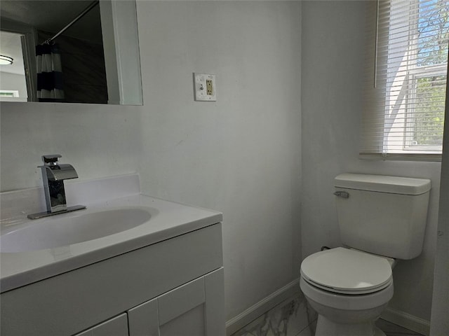 full bathroom with baseboards, marble look tile flooring, toilet, and vanity