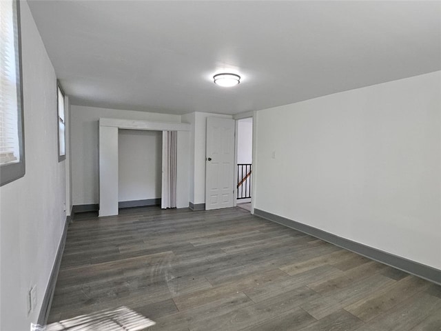 unfurnished room featuring wood finished floors and baseboards