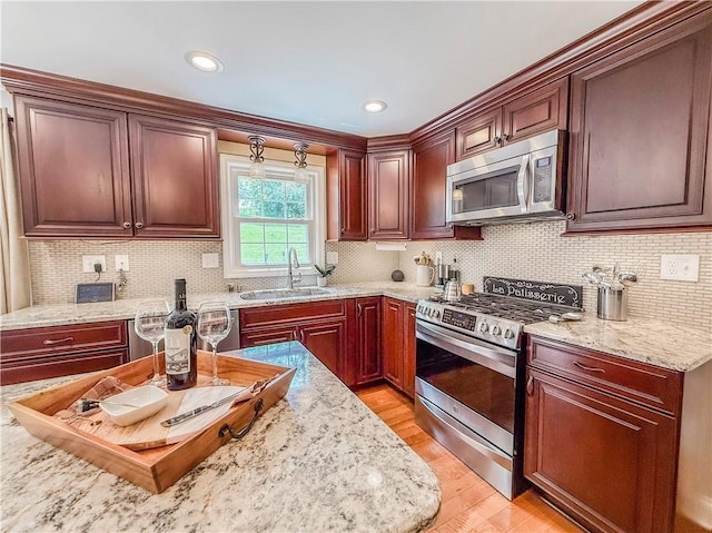 2388 Mill Grove Rd, Upper St Clair, PA 15241 - kitchen featuring stainless steel appliances, a sink, light wood-style flooring, backsplash, and recessed lighting