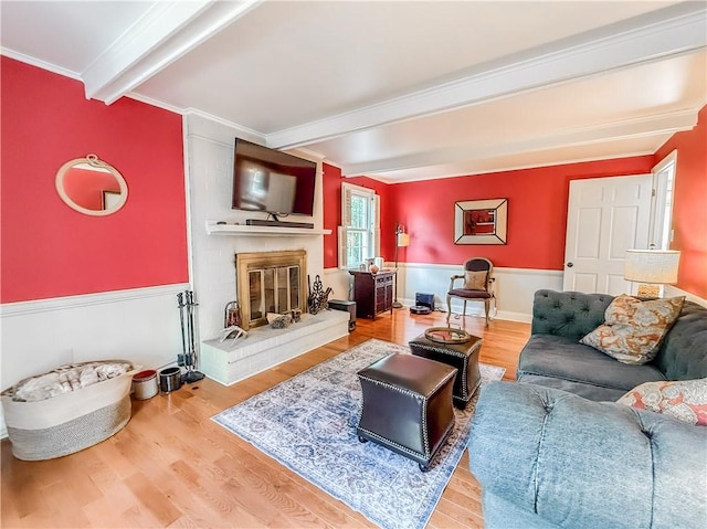 2388 Mill Grove Rd, Upper St Clair, PA 15241 - living room featuring beamed ceiling, wood finished floors, a wainscoted wall, a brick fireplace, and ornamental molding