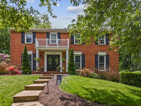 2388 Mill Grove Rd, Upper St Clair, PA 15241 - georgian-style home featuring a balcony, french doors, a front lawn, and brick siding
