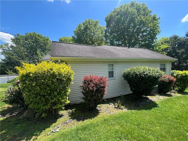 277 Widmer Ave, Lower Burrell, PA 15068 - view of home's exterior featuring a lawn and a shingled roof