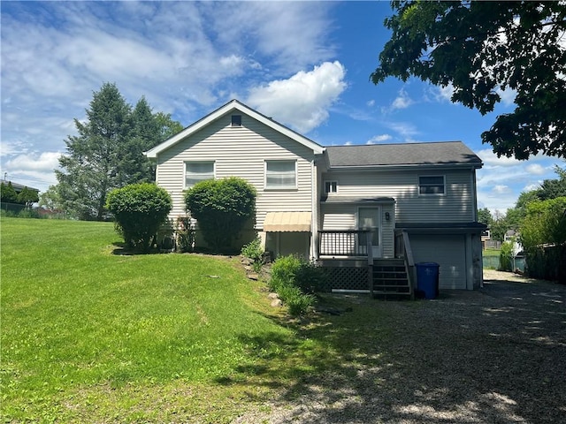 277 Widmer Ave, Lower Burrell, PA 15068 - back of property featuring an attached garage and a lawn