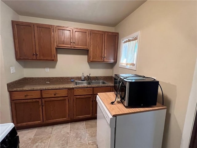 277 Widmer Ave, Lower Burrell, PA 15068 - kitchen featuring a sink, brown cabinetry, wood counters, and range
