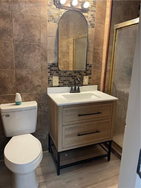218 S Mercer, Linesville Boro, PA 16424 - bathroom with tile walls, wood finished floors, vanity, and toilet