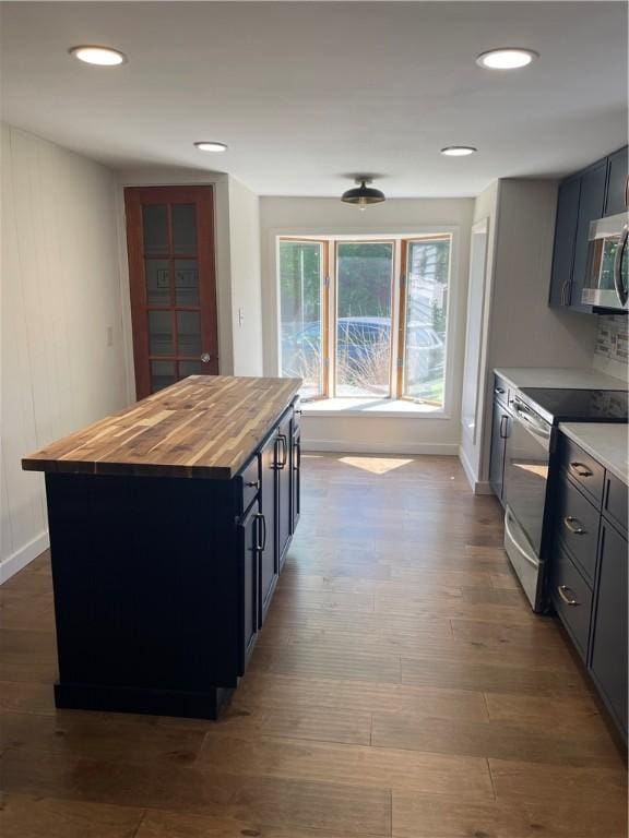 218 S Mercer, Linesville Boro, PA 16424 - kitchen with appliances with stainless steel finishes, butcher block countertops, dark wood-type flooring, a center island, and baseboards