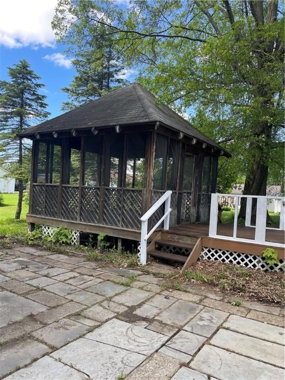 218 S Mercer, Linesville Boro, PA 16424 - exterior space featuring a sunroom, roof with shingles, and a wooden deck
