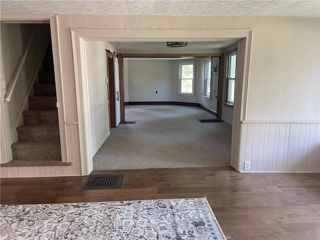 218 S Mercer, Linesville Boro, PA 16424 - hall featuring stairs, wood finished floors, a barn door, wainscoting, and crown molding