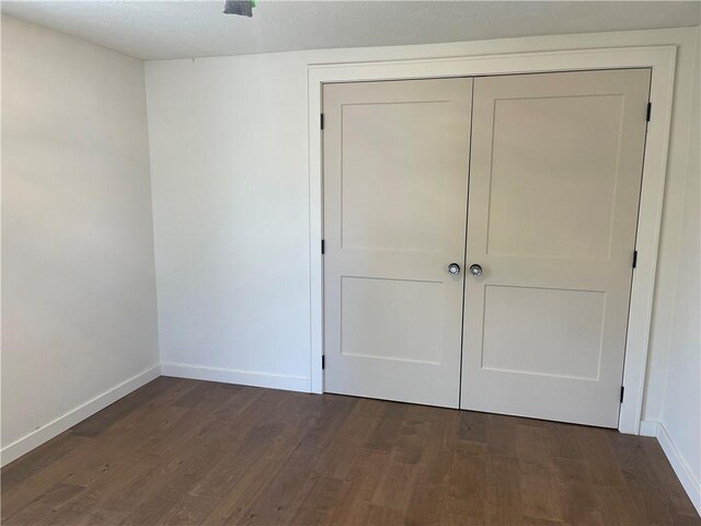 218 S Mercer, Linesville Boro, PA 16424 - unfurnished bedroom featuring baseboards, wood finished floors, and a closet