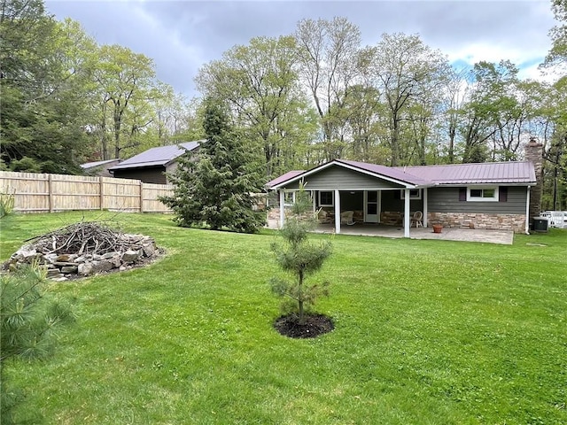 643 Laurel Summit Rd, Jenner Twp, PA 15531 - back of house featuring stone siding, a patio, a chimney, metal roof, and an outdoor fire pit