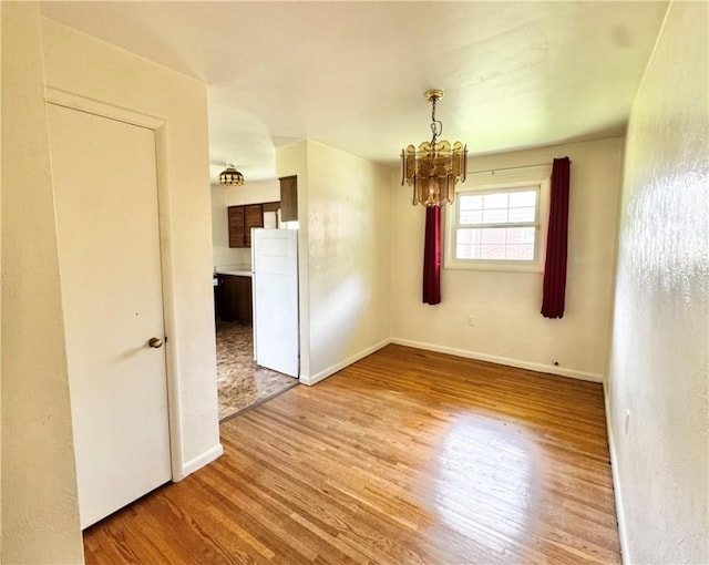 404 Belrose Dr, Rostraver, PA 15012 - unfurnished room featuring a chandelier, light wood-style floors, and baseboards