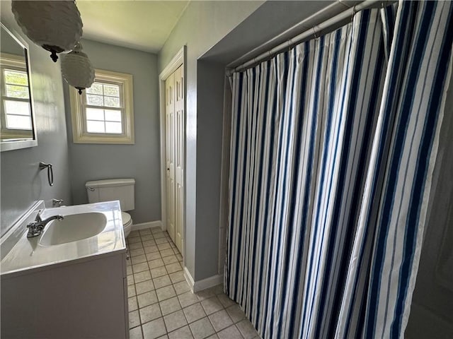 404 Belrose Dr, Rostraver, PA 15012 - bathroom with toilet, tile patterned floors, vanity, and baseboards