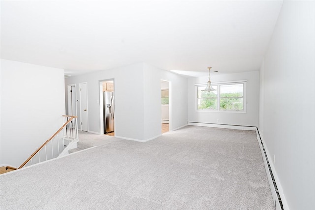 103 Shady Dr, White Twp Ind, PA 15701 - empty room with a baseboard radiator, light colored carpet, baseboards, and a baseboard heating unit