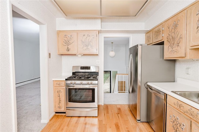 103 Shady Dr, White Twp Ind, PA 15701 - kitchen with appliances with stainless steel finishes, light wood finished floors, a baseboard radiator, and light countertops