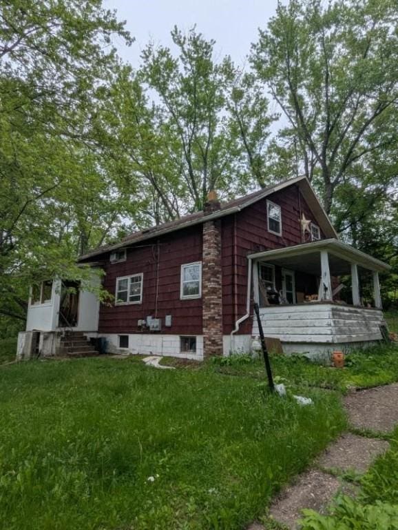 139 Stullville Rd, Leechburg Boro, PA 15656 - view of property exterior with entry steps, a chimney, and a lawn